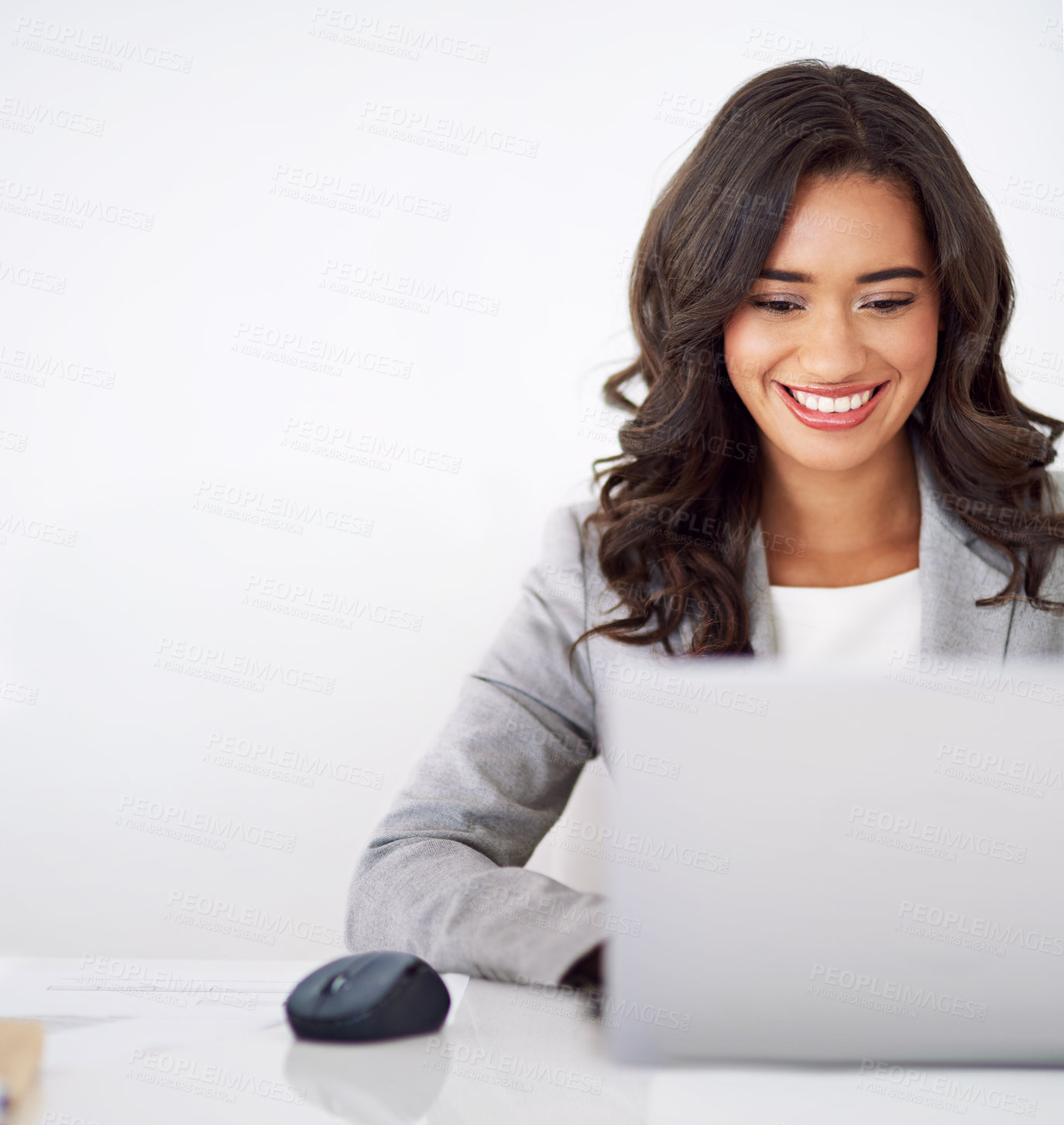 Buy stock photo Cropped shot of a young businesswoman working on her laptop