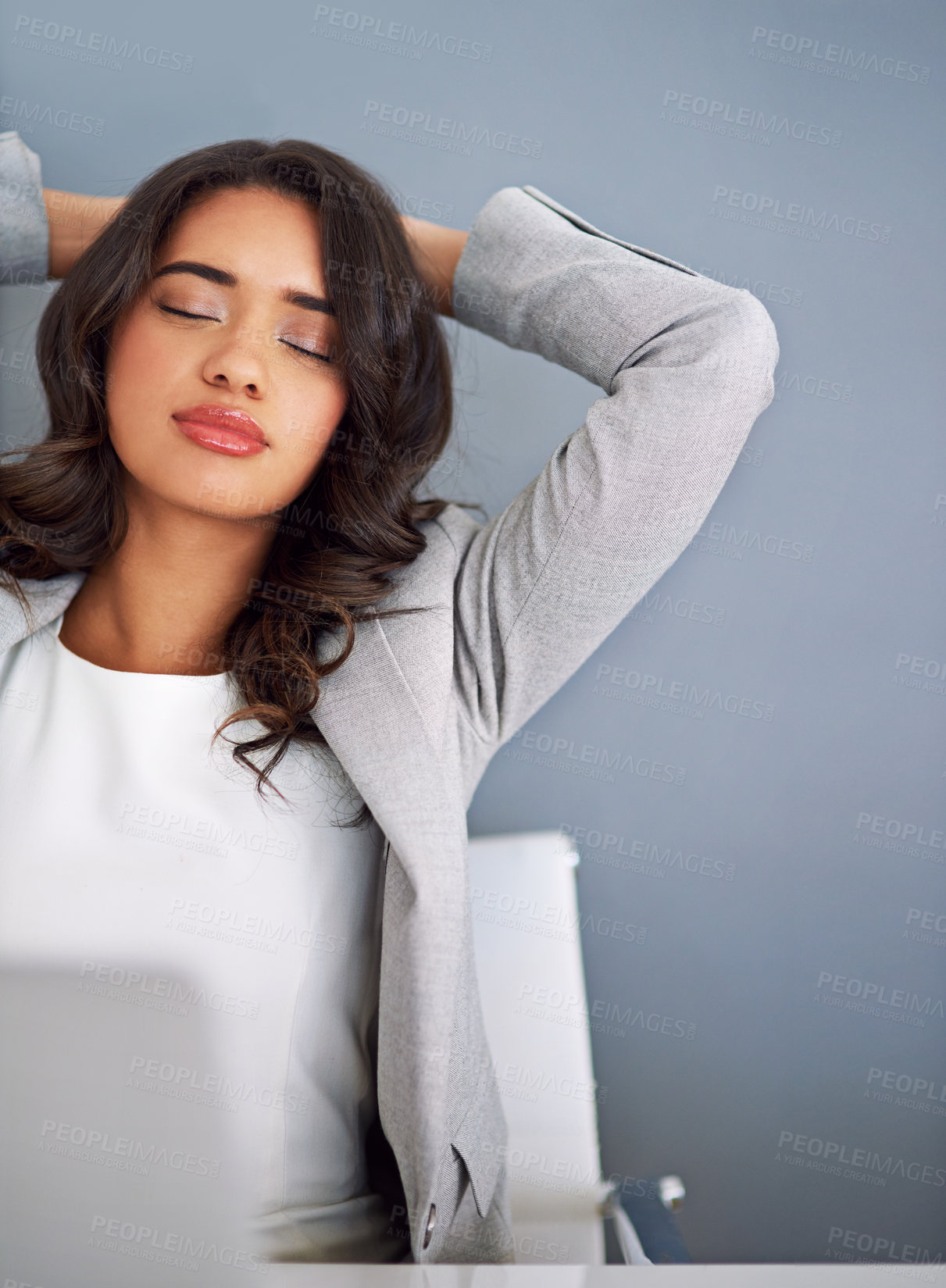 Buy stock photo Cropped shot of a young businesswoman looking relaxed while working on her laptop