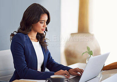 Buy stock photo Cropped shot of a young businesswoman working on her laptop