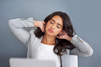 Buy stock photo Cropped shot of a young businesswoman looking stressed while working on her laptop