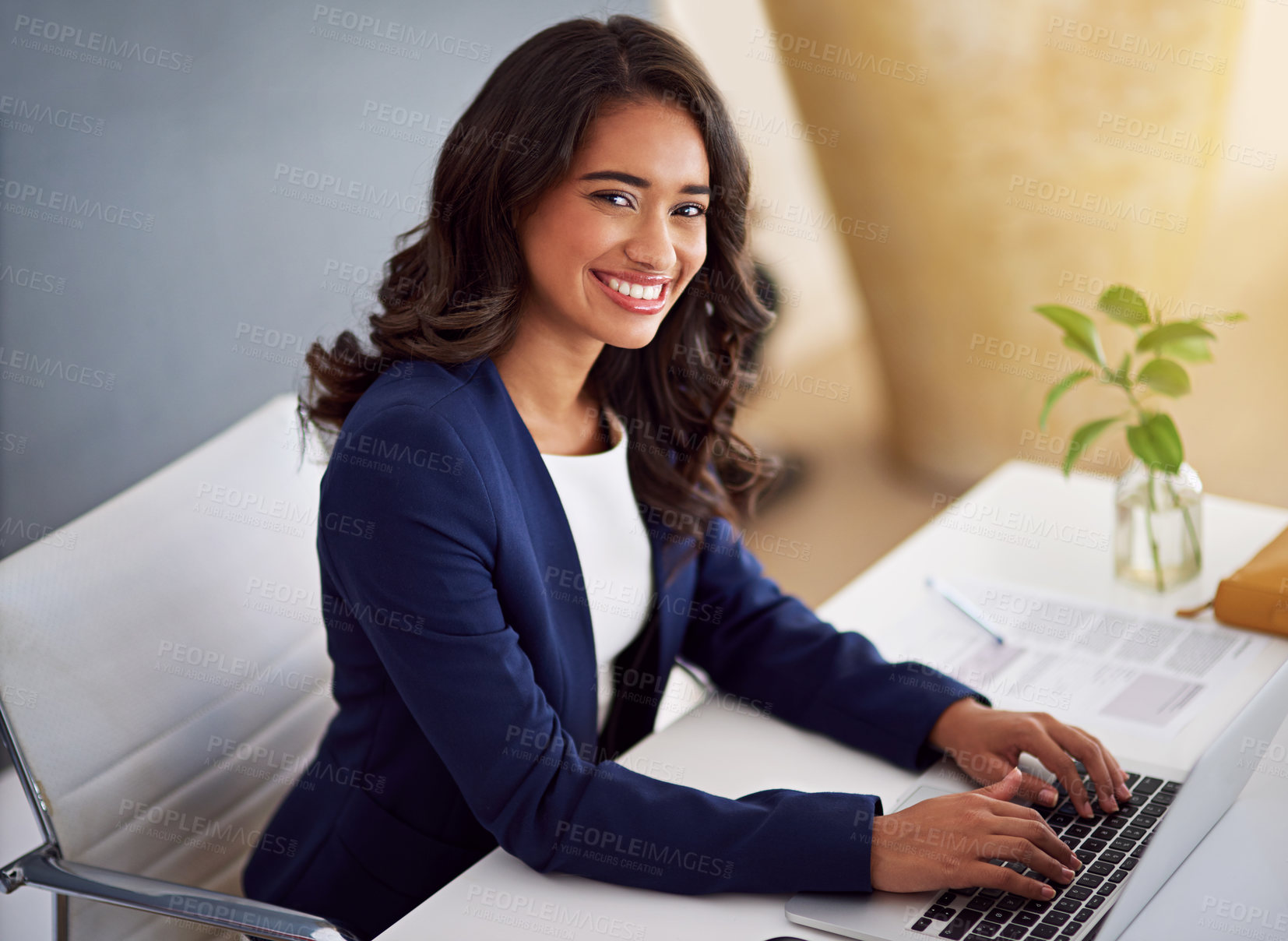 Buy stock photo Cropped portrait of a young businesswoman working on her laptop