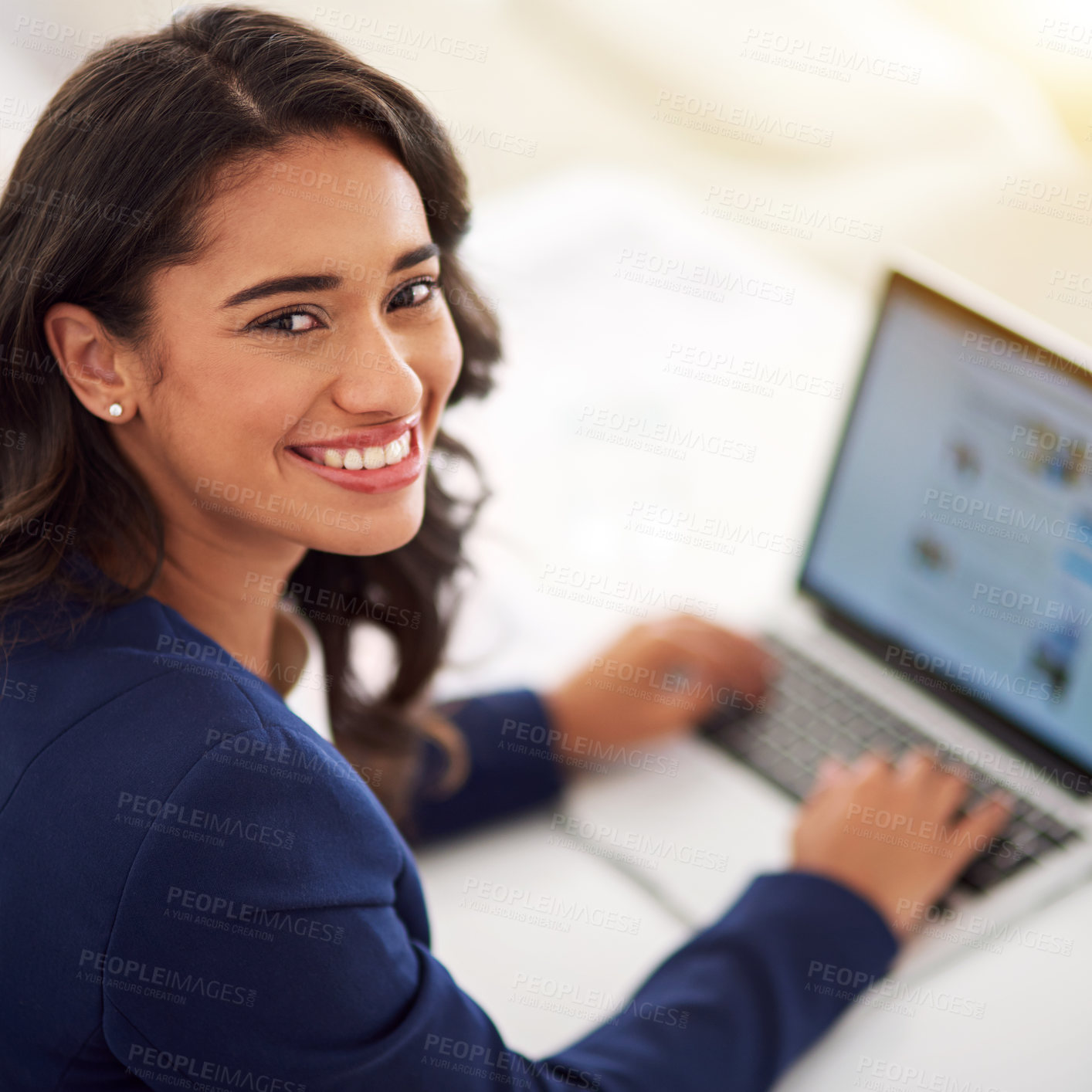 Buy stock photo Cropped portrait of a young businesswoman working on her laptop