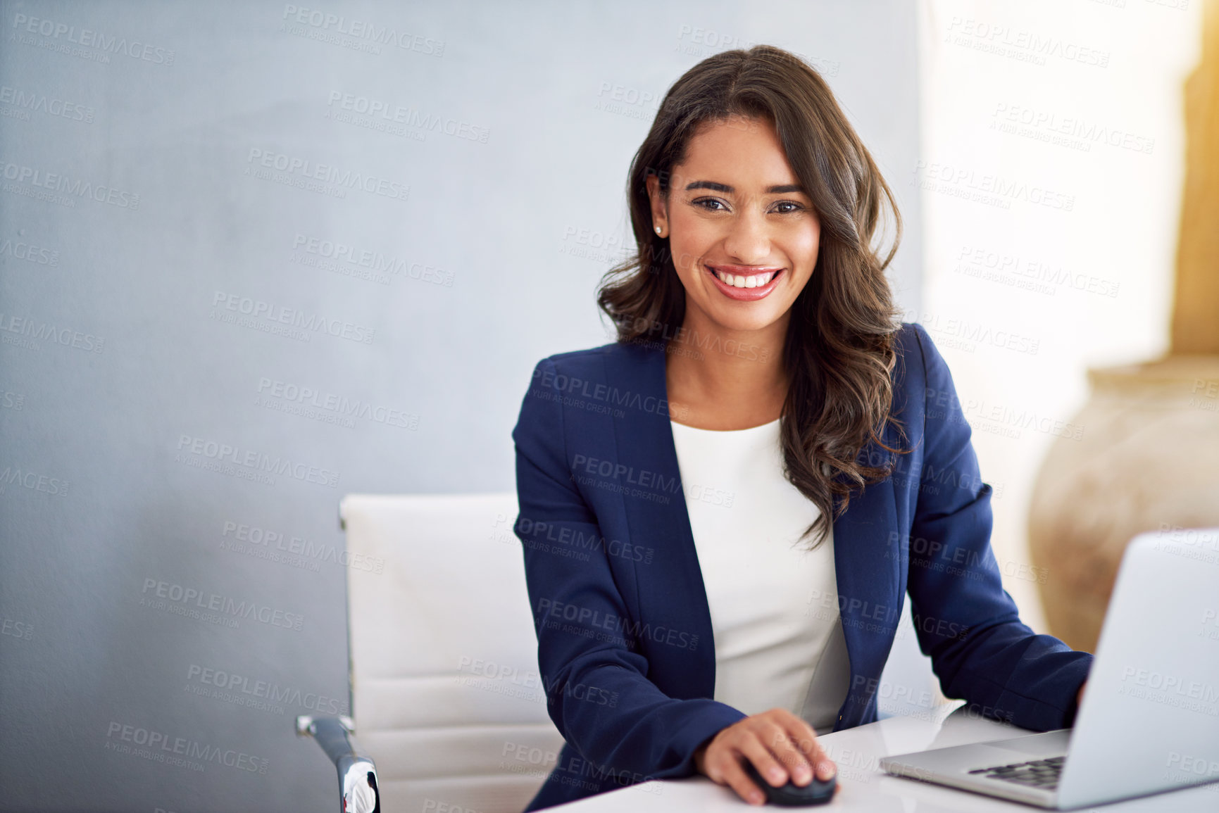 Buy stock photo Cropped portrait of a young businesswoman working on her laptop