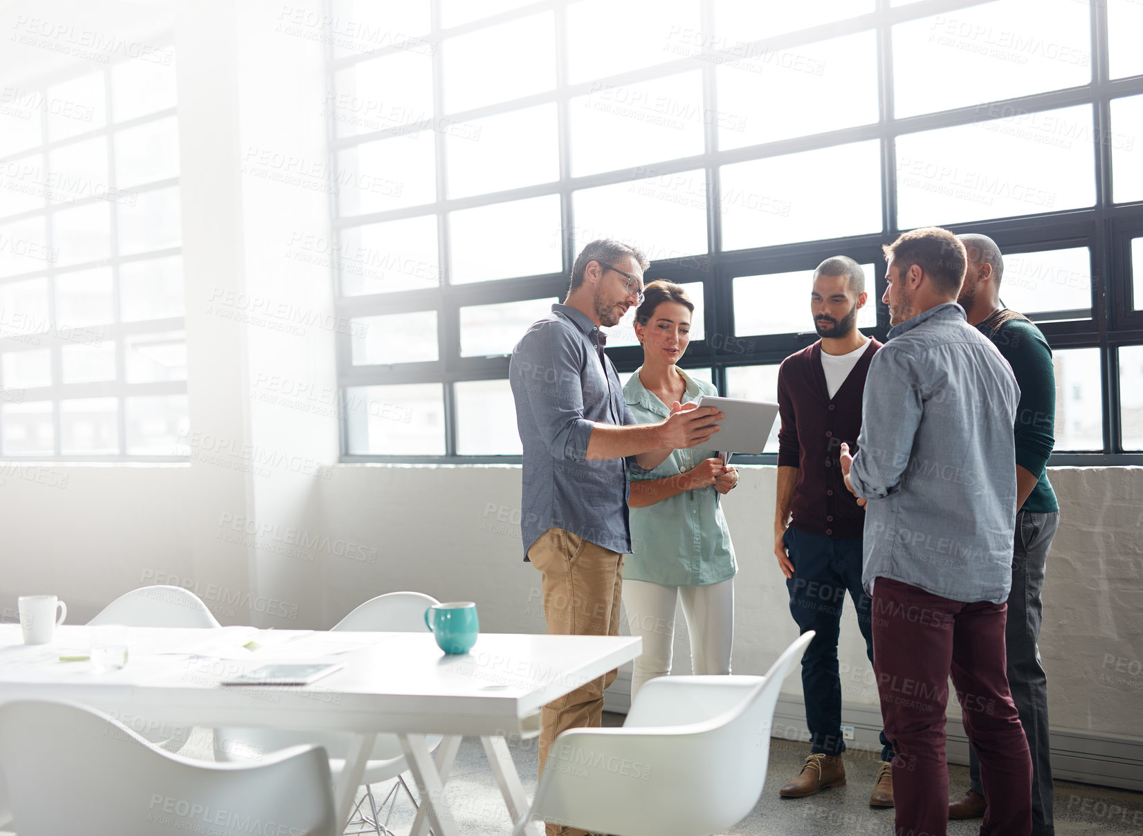 Buy stock photo Shot of a group of coworkers standing in the boardroom