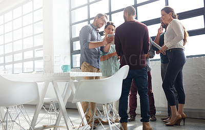 Buy stock photo Shot of a group of coworkers standing in the boardroom