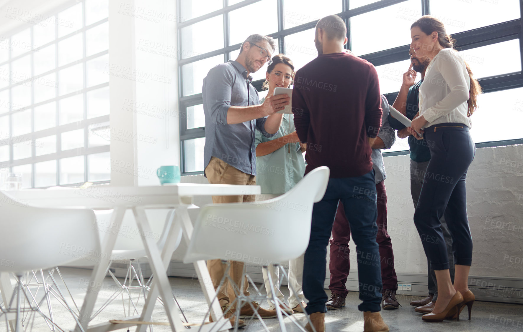 Buy stock photo Shot of a group of coworkers standing in the boardroom