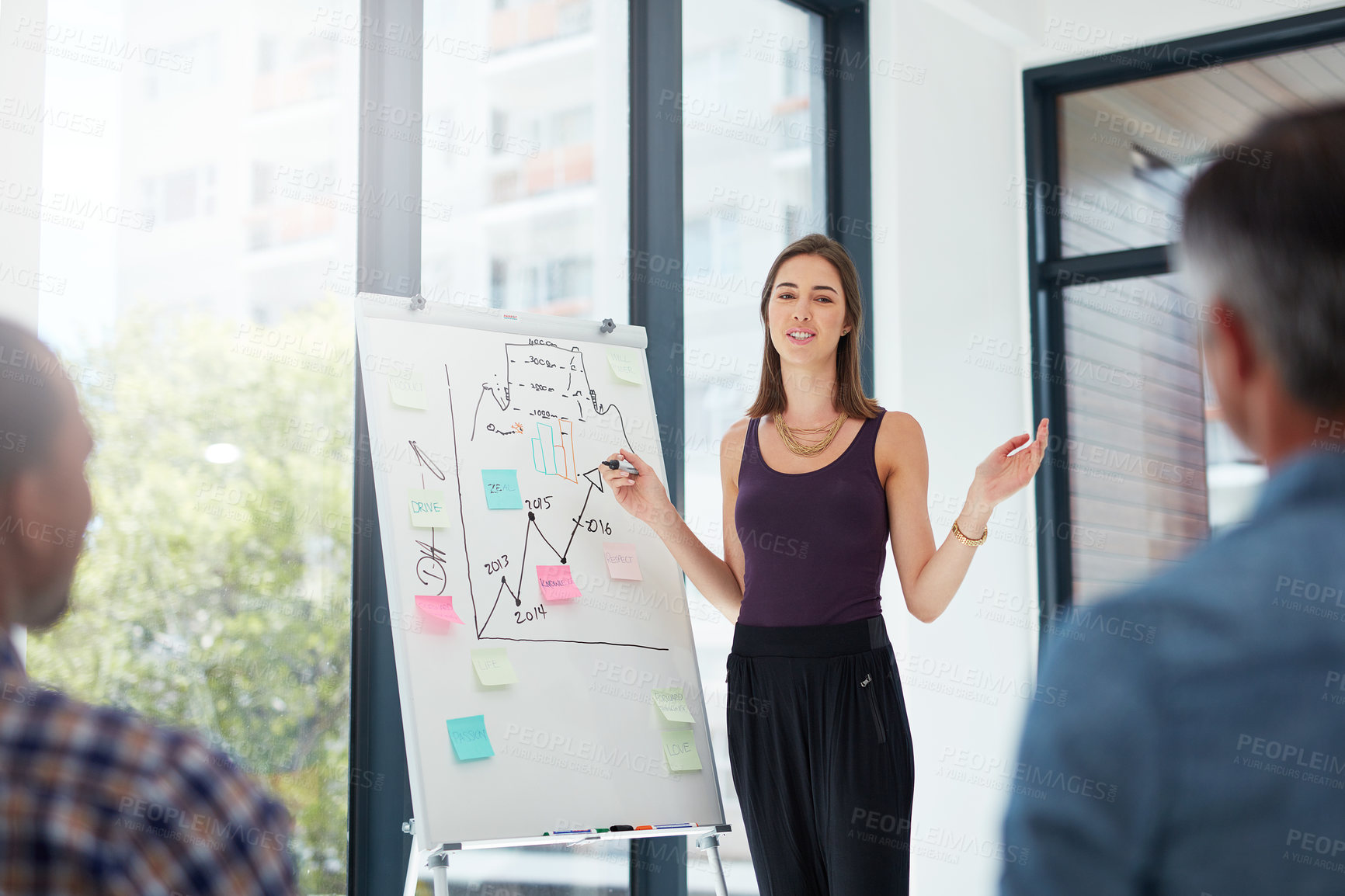 Buy stock photo Shot of a young businesswoman giving a presentation in the boardroom