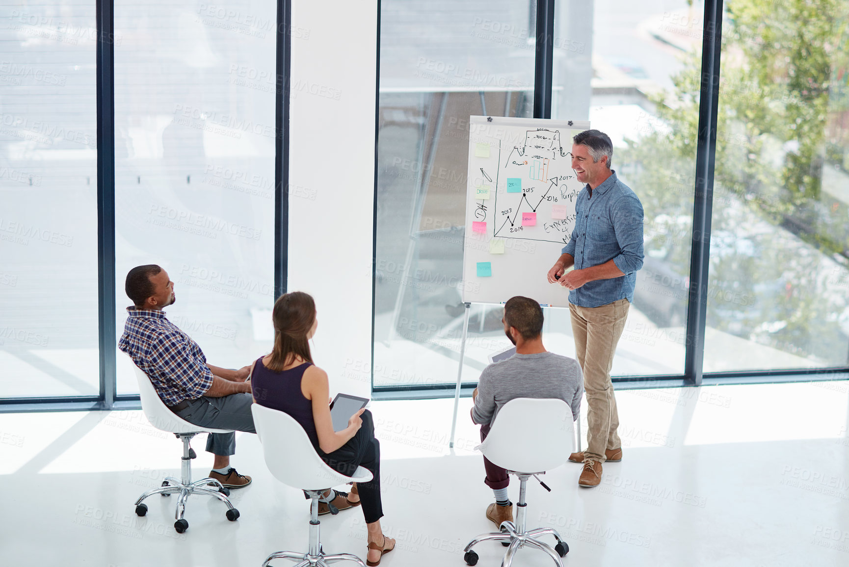 Buy stock photo Shot of a mature businessman giving a presentation in the boardroom