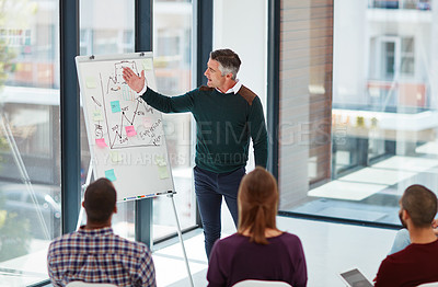 Buy stock photo Shot of a mature businessman giving a presentation in the boardroom