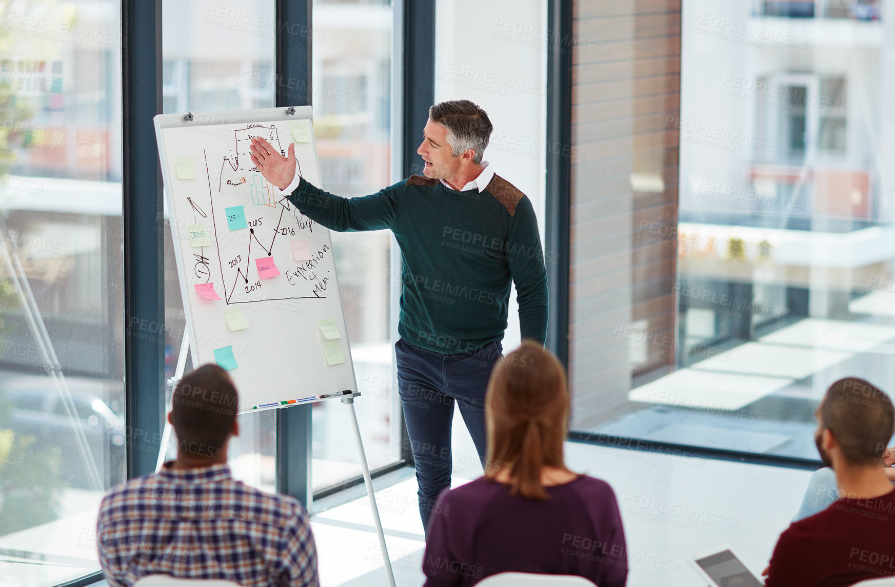 Buy stock photo Shot of a mature businessman giving a presentation in the boardroom