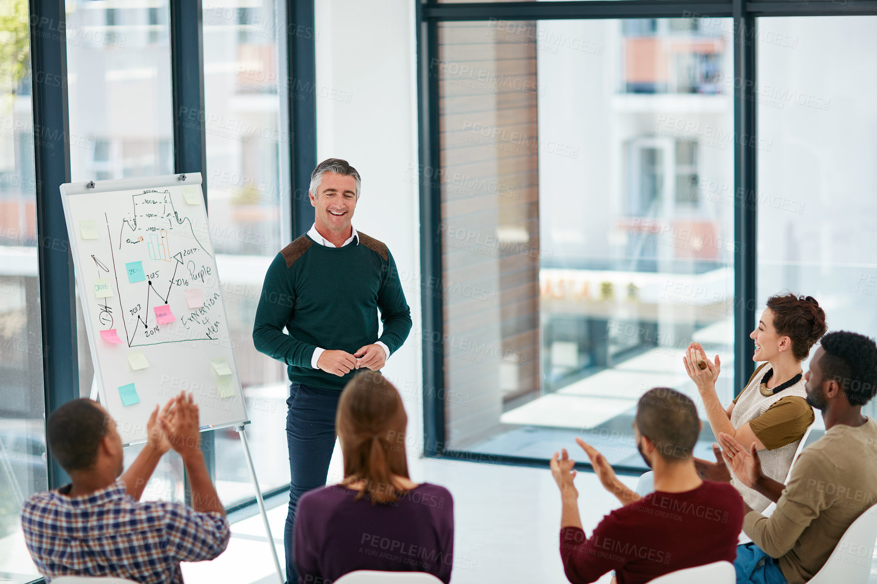 Buy stock photo Shot of a mature businessman giving a presentation in the boardroom