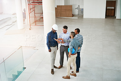 Buy stock photo High angle shot of businessmen talking in the lobby of their office