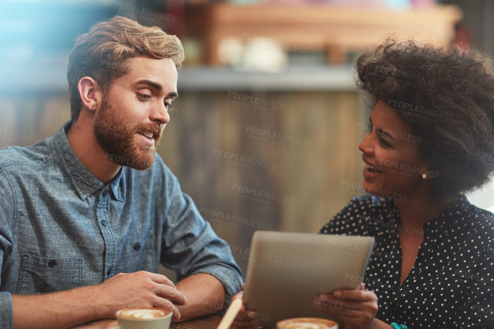 Buy stock photo Couple, tablet and happy on date in coffee shop with social media streaming, bonding and online information. Interracial, people and laughing in cafe for funny post update, comic discussion and relax