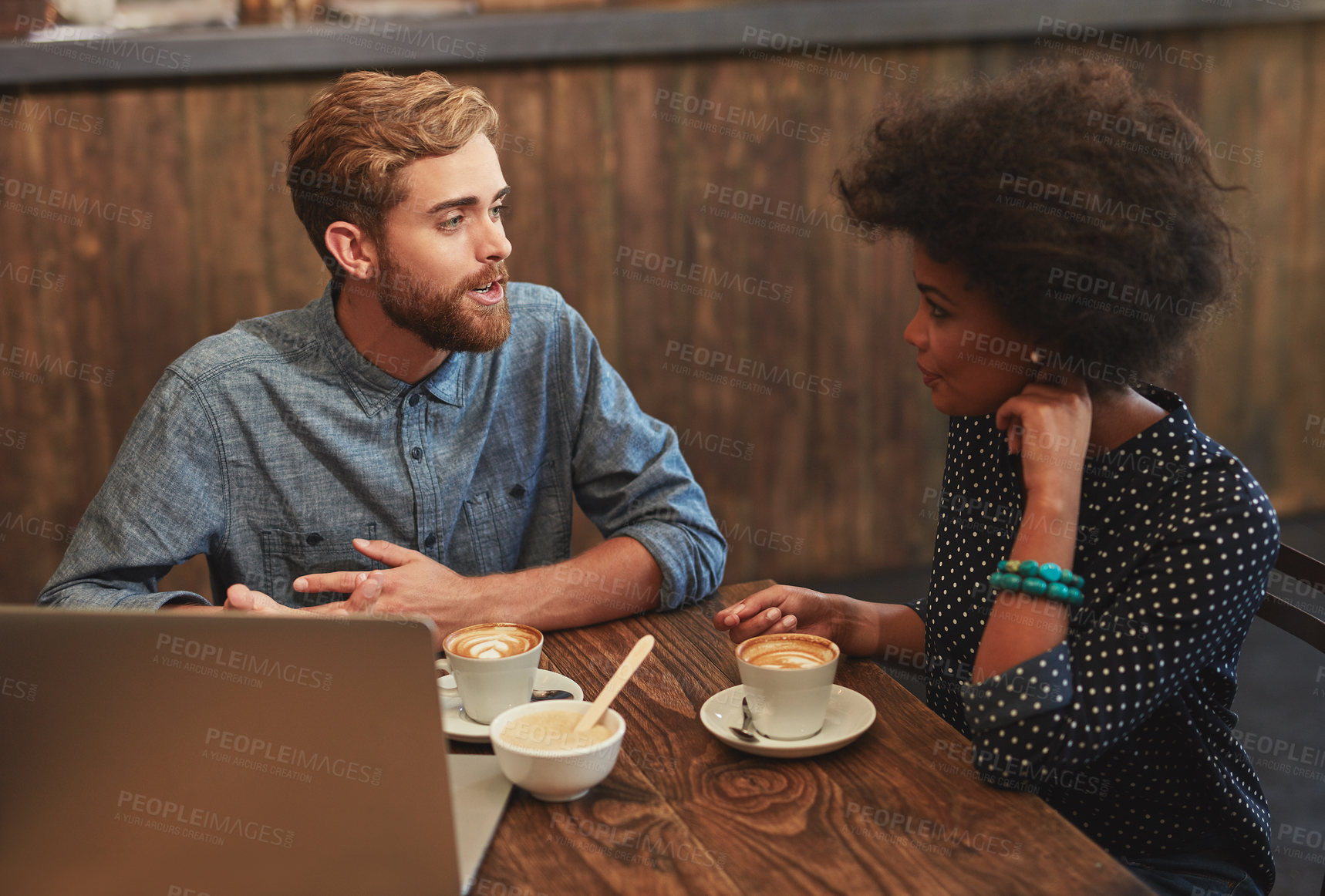 Buy stock photo Shot of a young couple on a coffee date