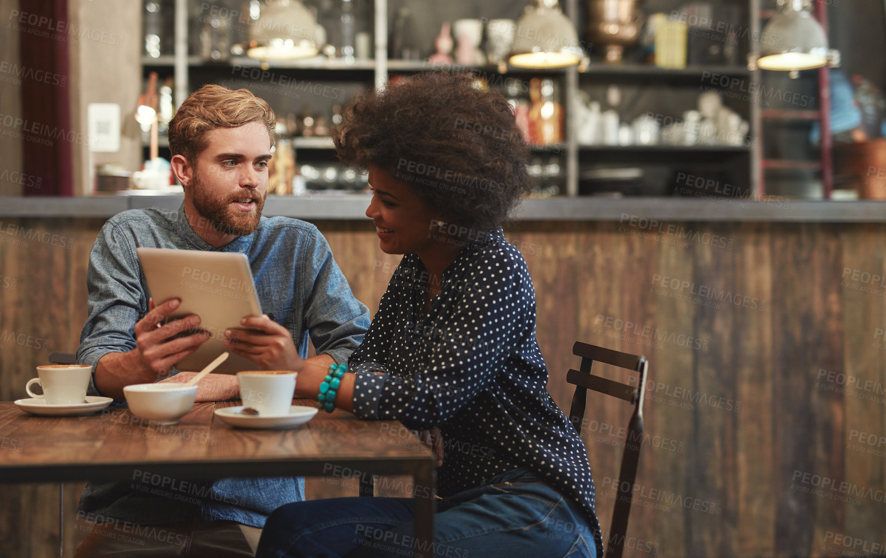 Buy stock photo Couple, tablet and laughing or smile in cafe with social media meme, bonding and funny online information. Interracial, people and happy in coffee shop with tech for comic post update or mockup space