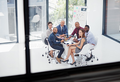 Buy stock photo Shot of a group of colleagues having a meeting in the boardroom