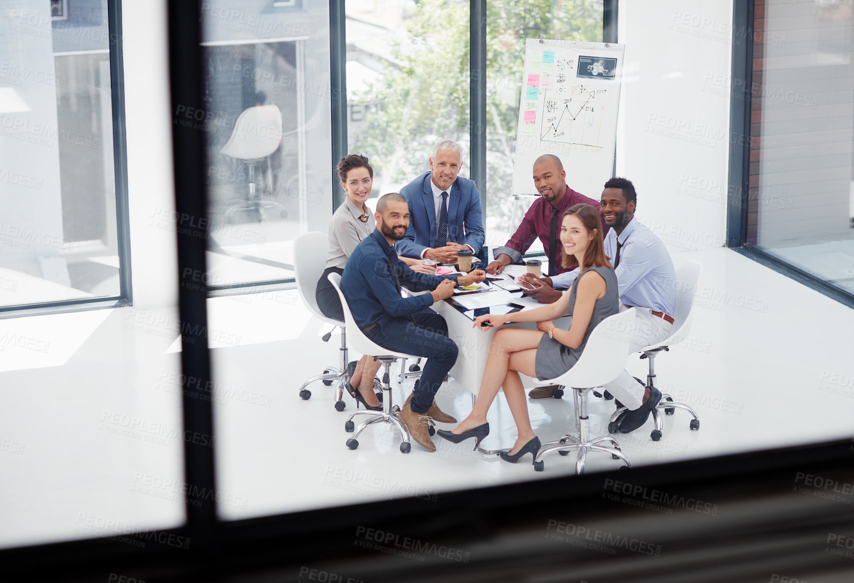 Buy stock photo Shot of a group of colleagues having a meeting in the boardroom