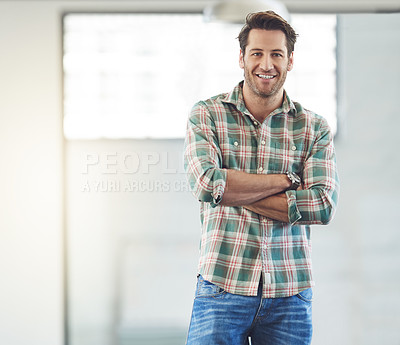 Buy stock photo Cropped portrait of a young male designer standing with his arms folded in the office