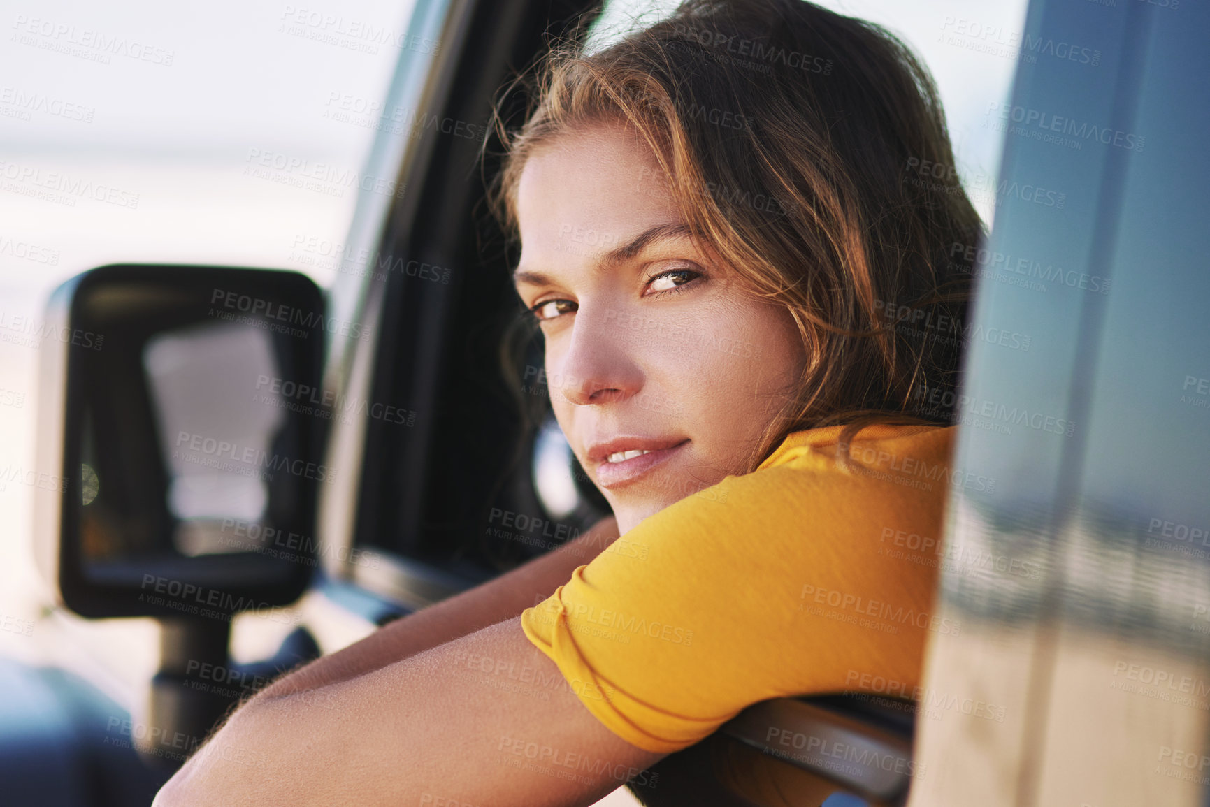 Buy stock photo Portrait of a young woman sitting in her car