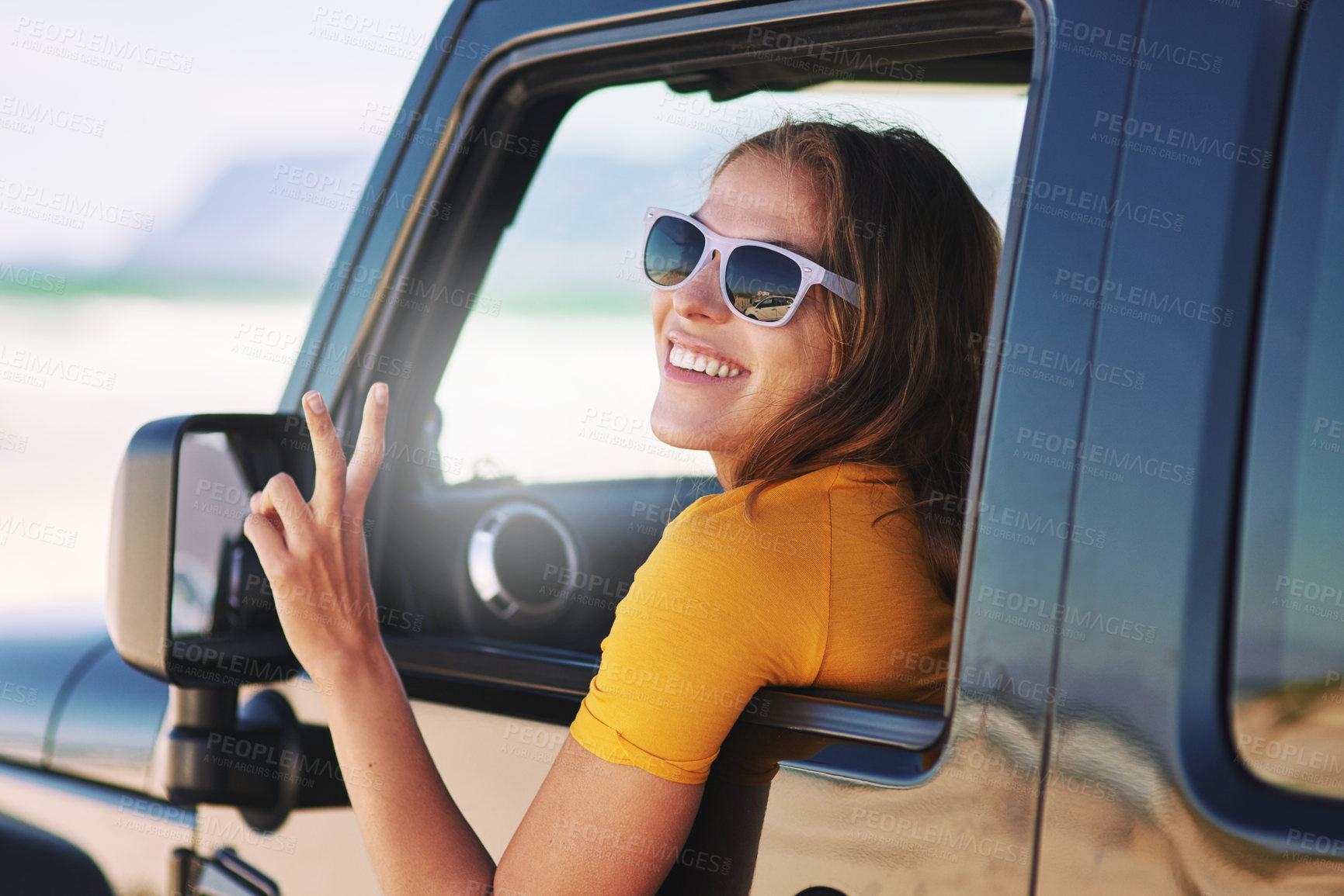 Buy stock photo Car, window and woman on road trip with peace sign, outdoor adventure and transport for desert vacation. Travel, fun and happy face of girl in van with driving, summer holiday and carefree journey