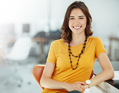 Buy stock photo Portrait, smile and a business woman in the office, sitting at her desk feeling positive about her career. Happy, professional and confidence with a young female employee looking cheerful at work