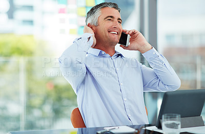Buy stock photo Cropped shot of a mature businessman talking on his cellphone while sitting in the office