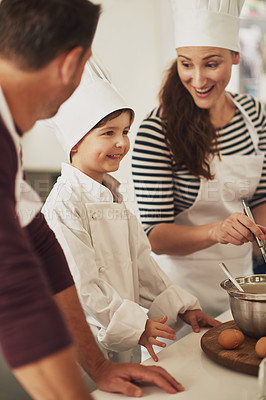 Buy stock photo Shot of a smiling family baking together in the kitchen