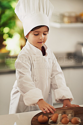 Buy stock photo Cropped shot of a young boy baking in the kitchen
