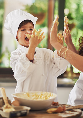 Buy stock photo Shot of a mother and her young son baking together in the kitchen