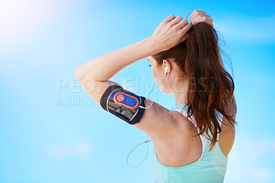 Buy stock photo Fitness, woman tying her hair for running workout, health and wellness outdoor. Training, sports runner or healthy girl athlete with mockup blue sky ready for run or start cardio exercise with music