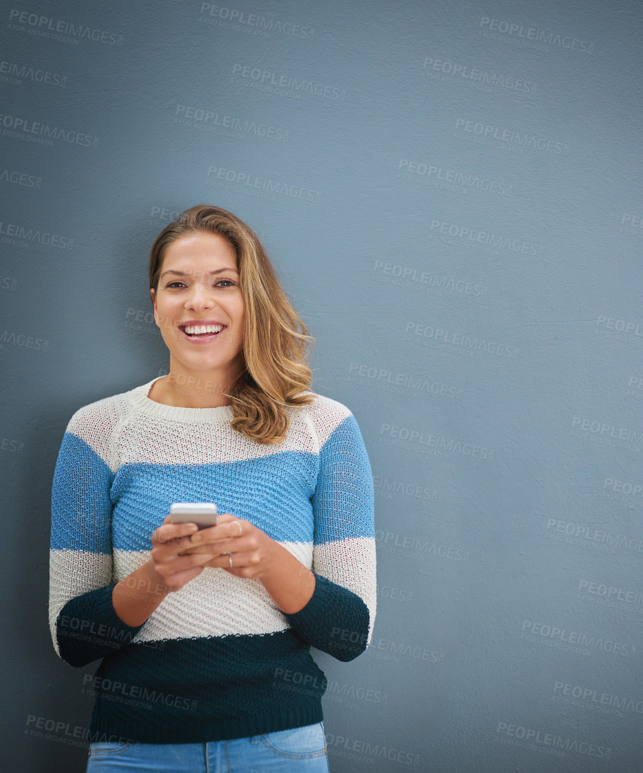 Buy stock photo Woman, phone and texting in studio portrait with smile, notification and mock up space by background. Person, smartphone and happy with social network, contact and connection with mobile app for chat