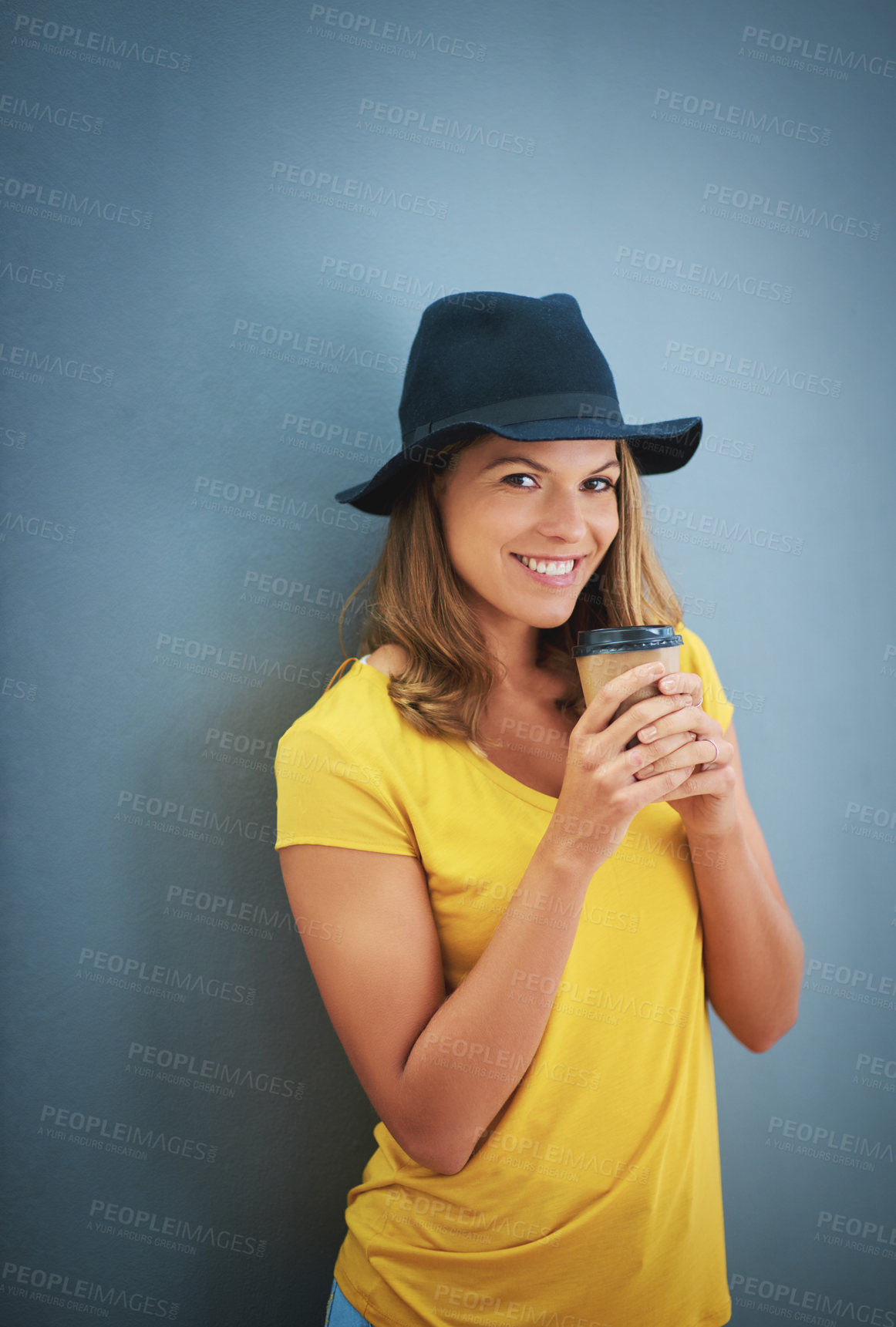 Buy stock photo Woman, fashion or coffee cup on blue background studio and marketing mockup, advertising space or mock up branding. Portrait, smile or happy student and takeaway hot drink, trend hat or style clothes