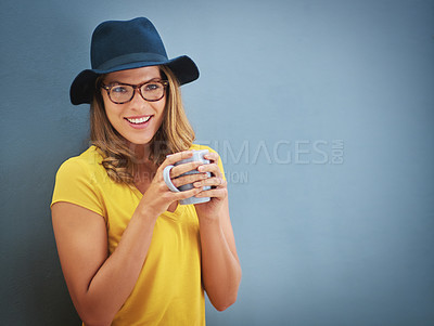 Buy stock photo Portrait of a young woman drinking a cup of coffee against a grey background