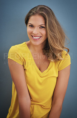 Buy stock photo Shot of a young woman posing against a gray wall