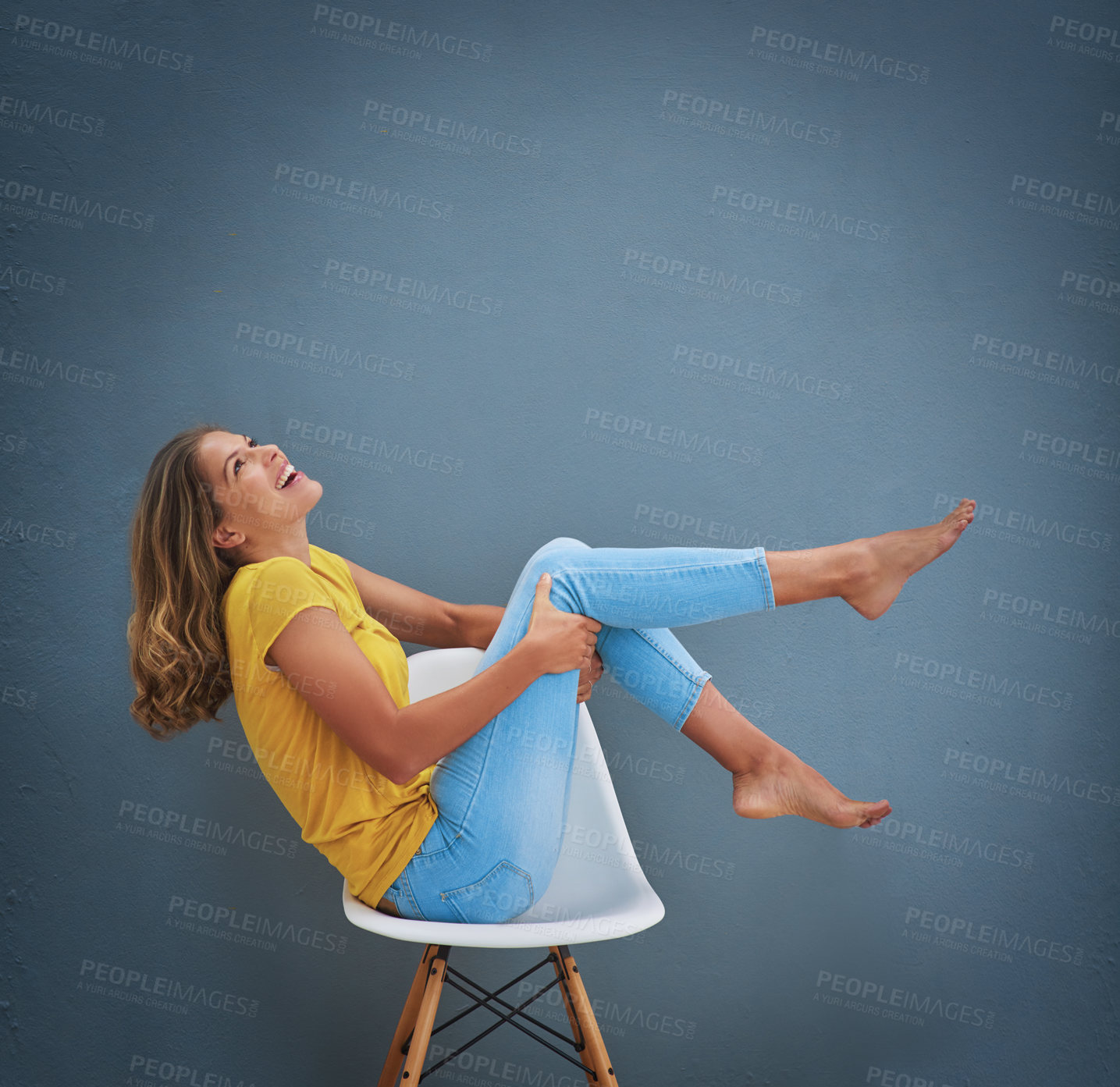 Buy stock photo Excited, woman and thinking on chair for fashion, style and relax in studio for aesthetic. Happy, model girl and mockup with denim or jeans, t shirt and memory or idea for outfit by gray background