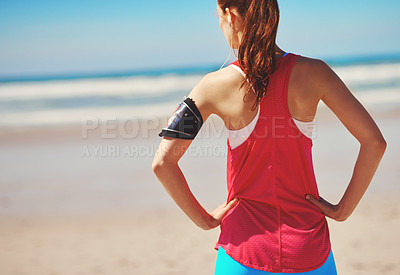 Buy stock photo Beach, fitness and woman athlete by the sea looking at ocean back view before running workout. Health, wellness and freedom feeling outdoor in summer for exercise, sports and headphones with music