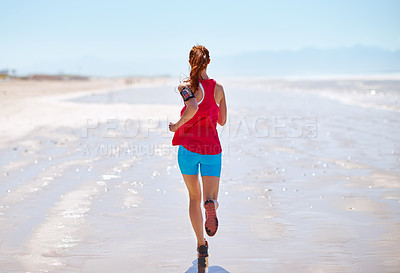 Buy stock photo Rearview shot of a young woman running on the beach