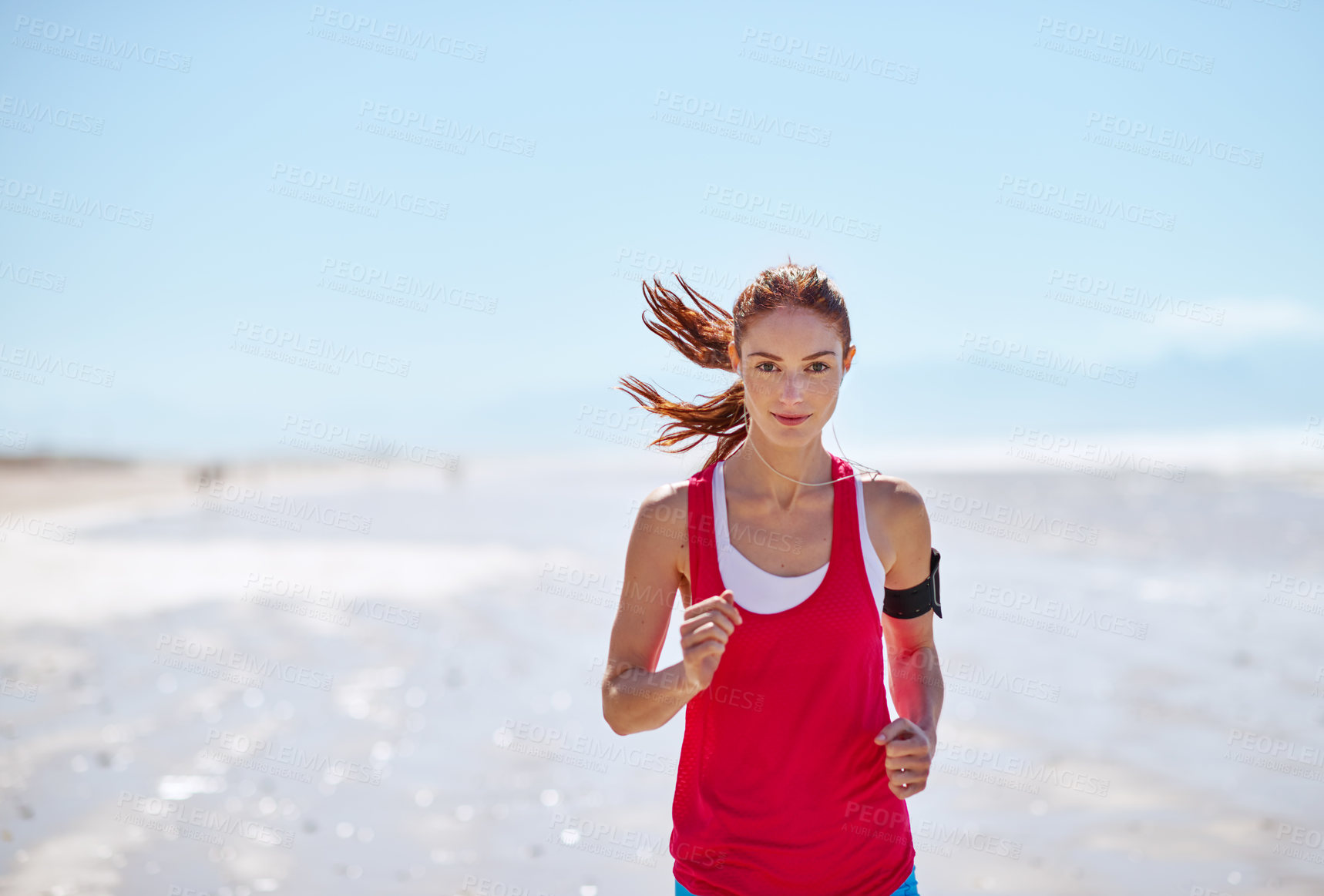 Buy stock photo Cropped shot of a young woman running on the beach