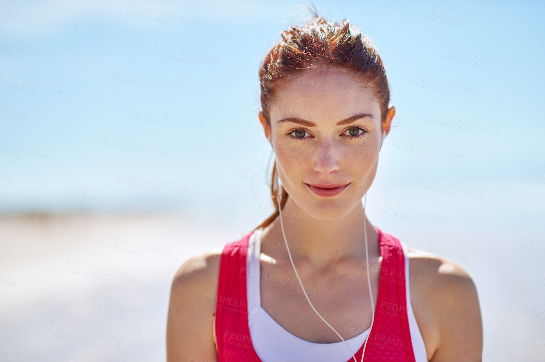 Buy stock photo Portrait, woman and music on beach for fitness, exercise and outdoor workout in summer. Runner or athlete, smile and earphones for podcast, audio and media for sports or marathon training in nature