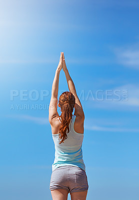 Buy stock photo Woman, exercise and yoga for meditation with hands in air against blue sky for freedom, health and wellness outdoor. Fitness model in prayer pose for workout, mindfulness and mental health meditation