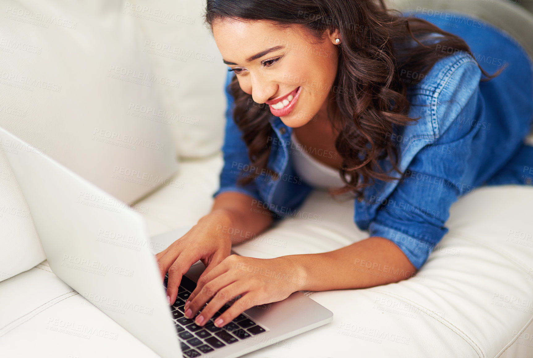 Buy stock photo Relax, happy woman and typing on laptop on sofa for hybrid work, blog or reading email. Computer, freelancer and girl in living room for writing script, story and writer research information in home