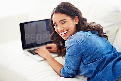 Buy stock photo Shot of a young woman browsing the web on her laptop at home