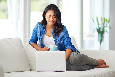 Buy stock photo Laptop, relax with coffee and black woman on sofa reading email, checking social media or streaming movie at home. Weekend, woman on couch with computer and a coffee break in living room on internet.