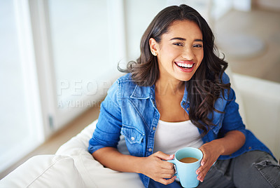 Buy stock photo Shot of a young woman drinking coffee while relaxing at home