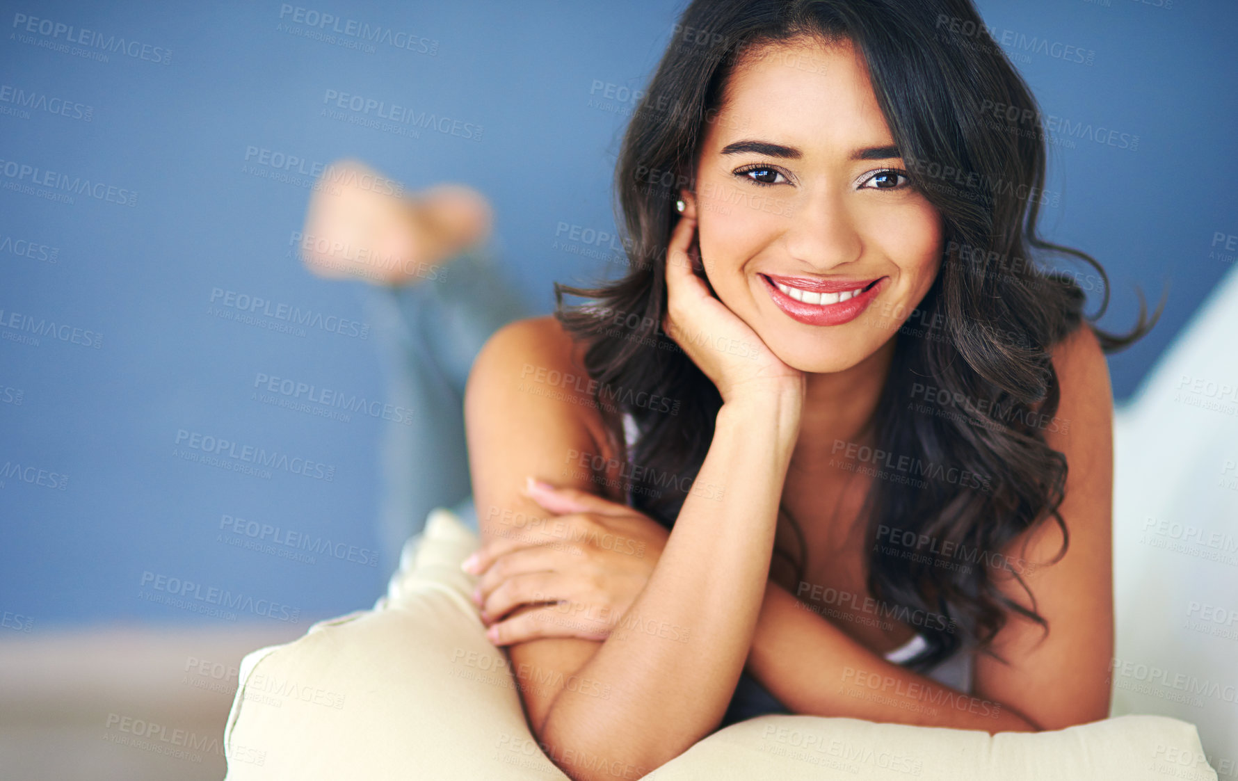 Buy stock photo Portrait of a young woman lying on her living room sofa