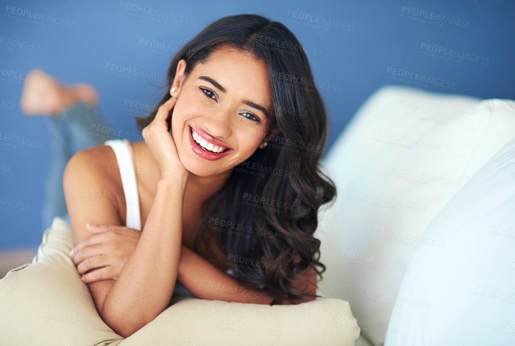 Buy stock photo Portrait of a young woman lying on her living room sofa
