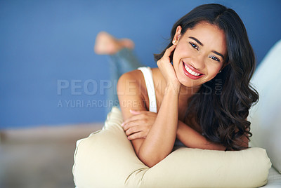 Buy stock photo Face, portrait and woman lying on sofa in living room of home alone. Happy, smile and young female from India relaxing on her comfortable couch in lounge, smiling and enjoying quality time in house.