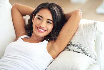 Buy stock photo Woman, portrait and relax on sofa in house, home or hotel living room in holiday break, Portugal vacation and self care. Smile, happy and person lying with hands behind head in hospitality apartment