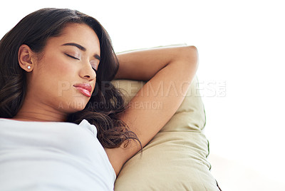 Buy stock photo Shot of a young woman asleep on her sofa
