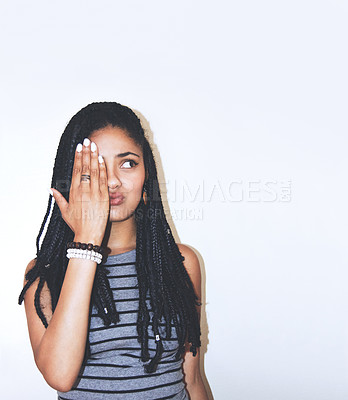 Buy stock photo Studio shot of an attractive young woman with her hand over one eye